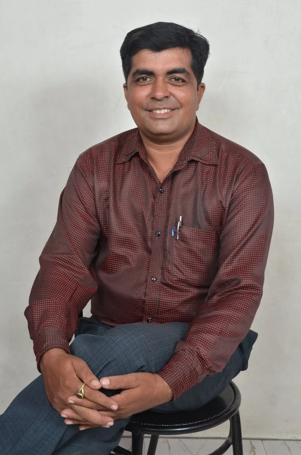 Dr. Avadhesh Kaushik seated for a formal author portrait