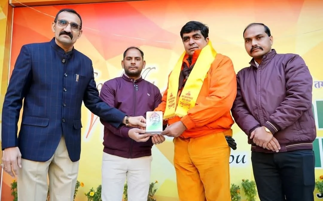 Stage ceremony with dignitaries in saffron attire